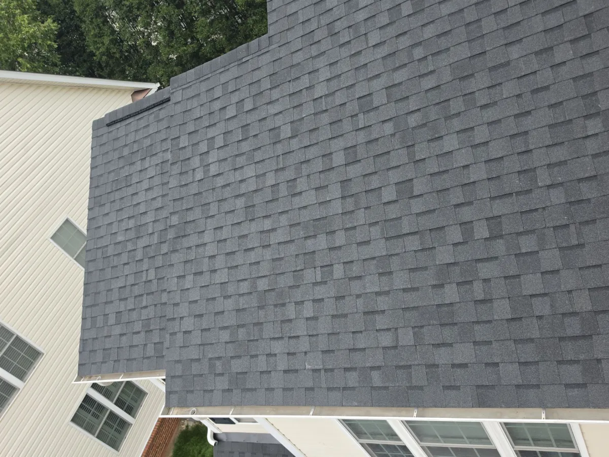 Finished roof meeting the wall with new flashing in Ashburn, VA