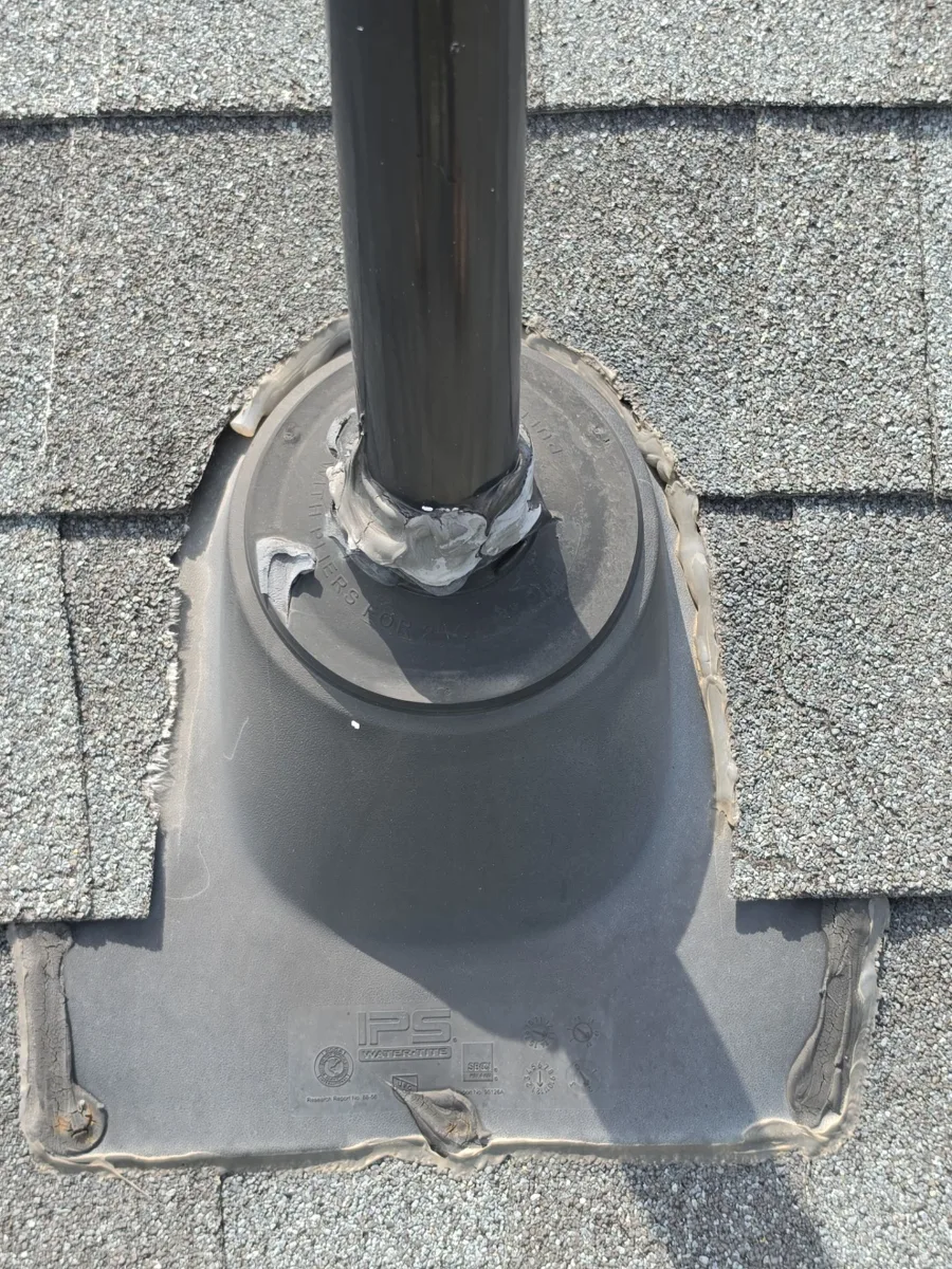 Failed plastic pipe boot patched with tape on a Hamilton, VA roof