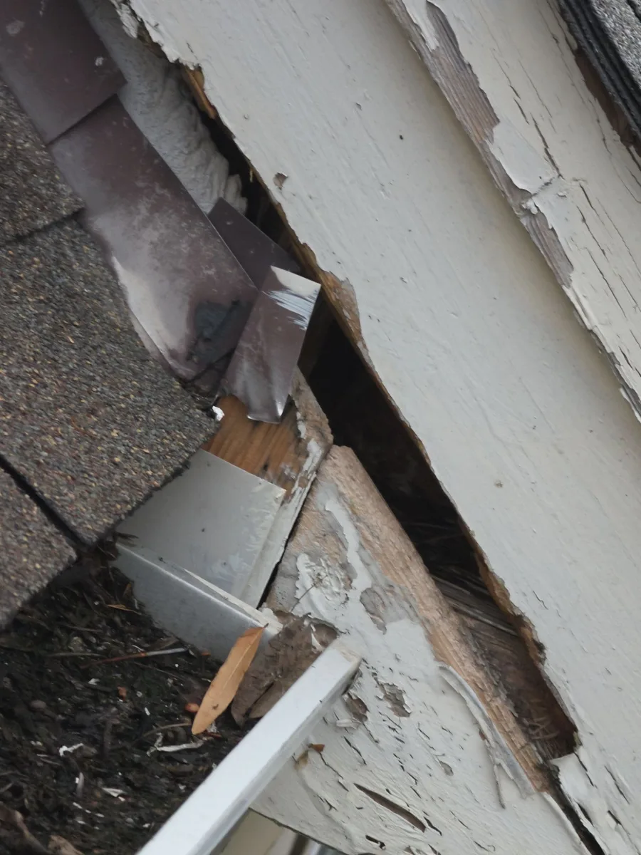 Failed flashing and damaged trim at a roof corner in Leesburg, VA