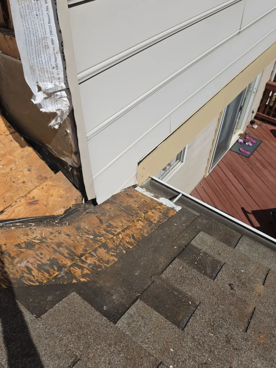 Rotted roof decking along the wall exposed during a leak repair in Leesburg, VA