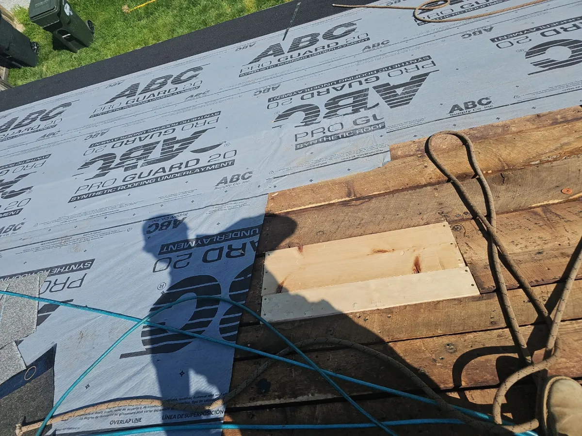 New synthetic underlayment going down on bare decking during a roof replacement in Purcellville, VA