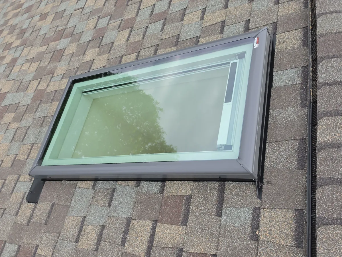 One of two new skylights with new shingles on a finished roof in Sterling, VA