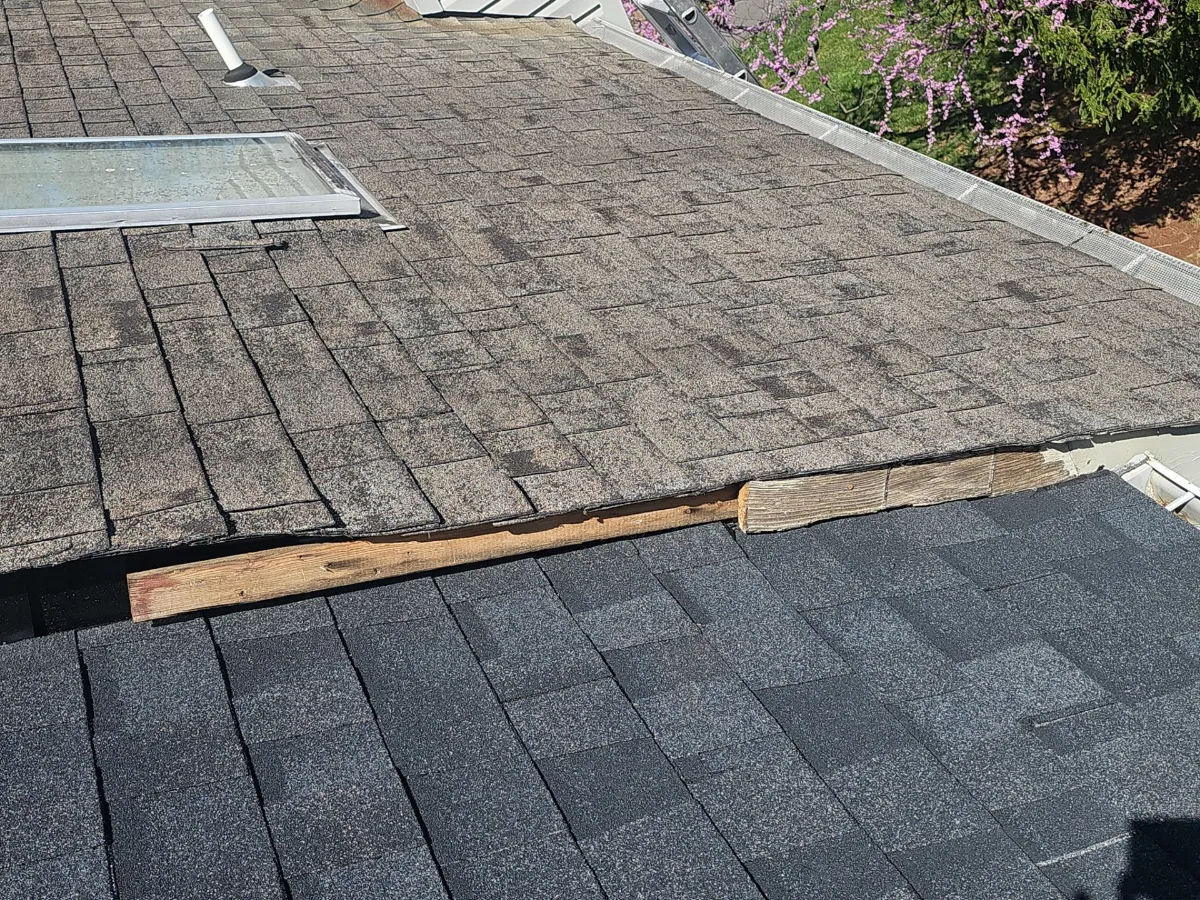 Worn roof shingles before replacement on a Sterling, VA townhouse